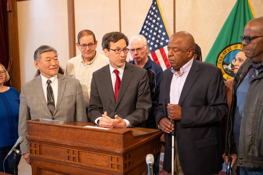 John Houston, Governor Bob Ferguson, Senator Bob Hasegawa, and supporters at the signing of SB 5142.