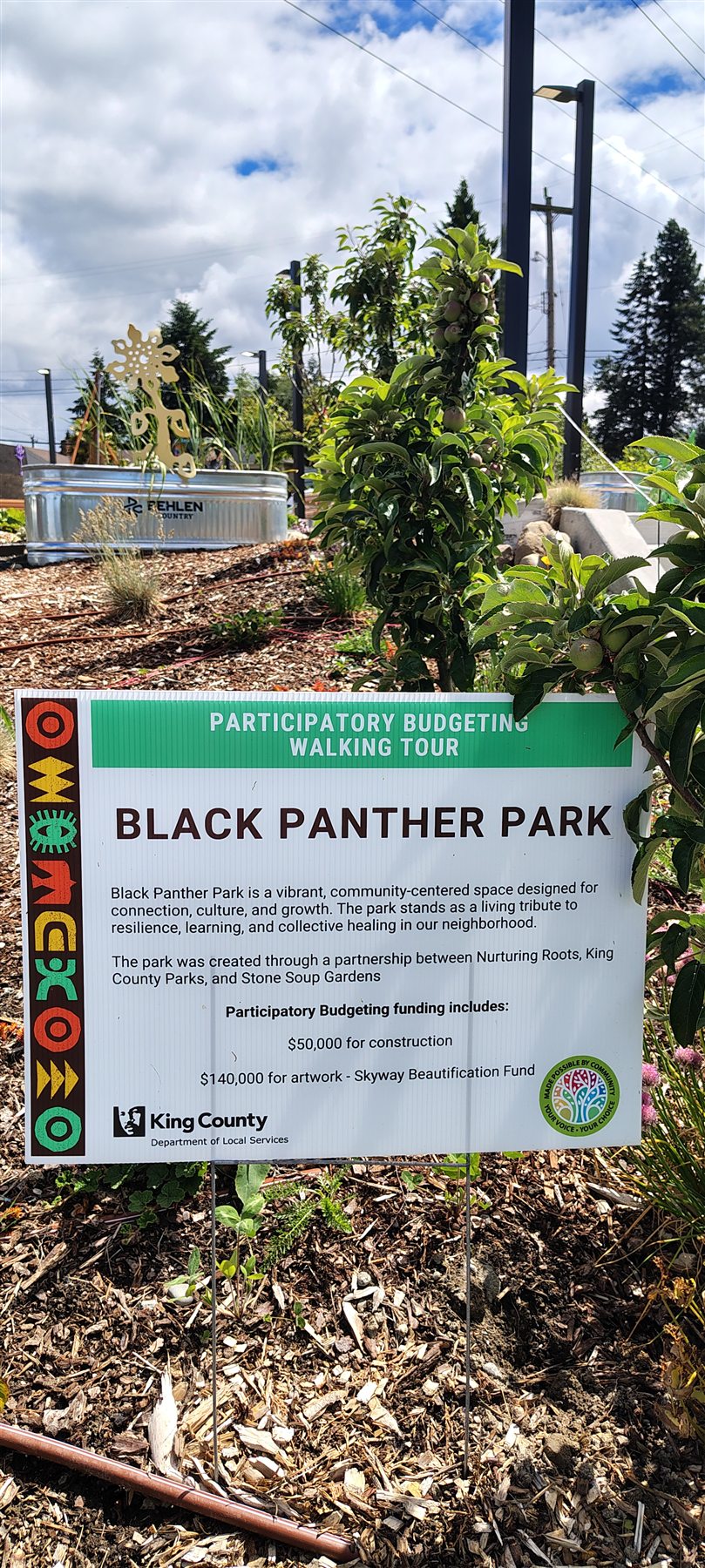 Black Panther Park sign describing the community-centered space and its partners.