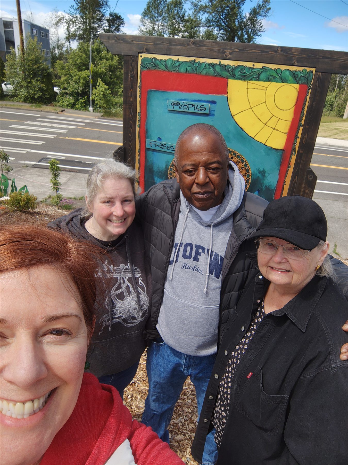 John Houston and community members together among the artwork at Black Panther Park.
